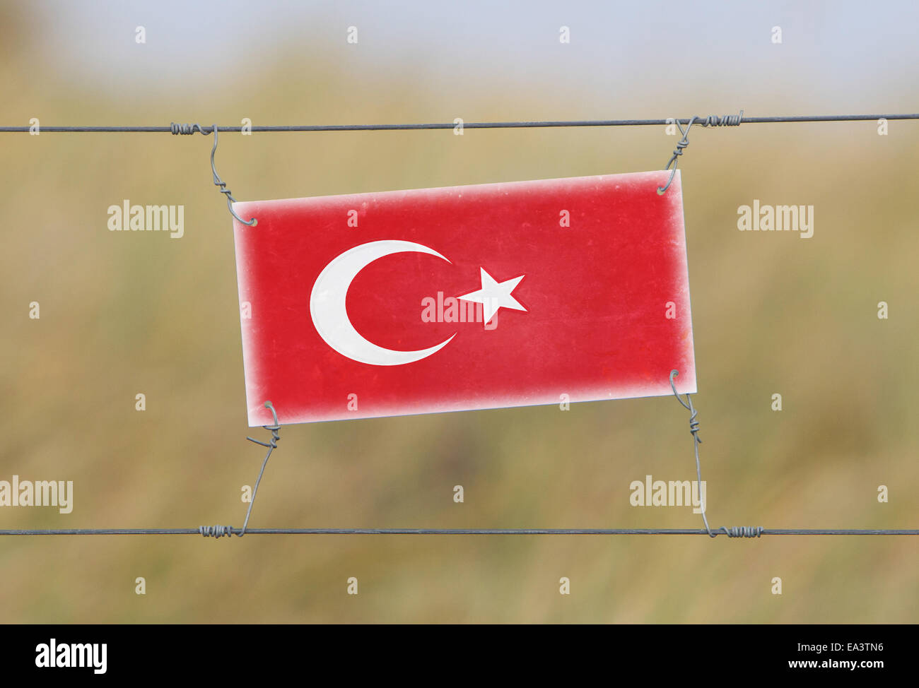 Border fence - Old plastic sign with a flag - Turkey Stock Photo