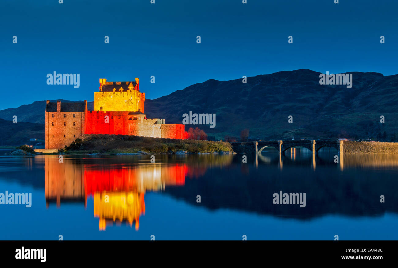 EILEAN DONAN CASTLE SCOTLAND AND BRIDGE WITH EVENING  RED LIGHT REFLECTIONS FOR ARMISTICE DAY NOVEMBER 11 2014 Stock Photo