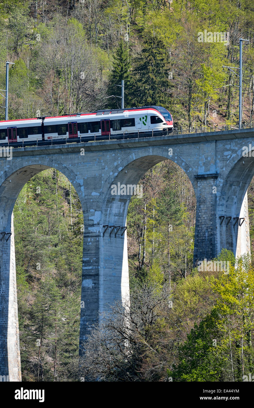 Modern Swiss train high on an old trestle Stock Photo