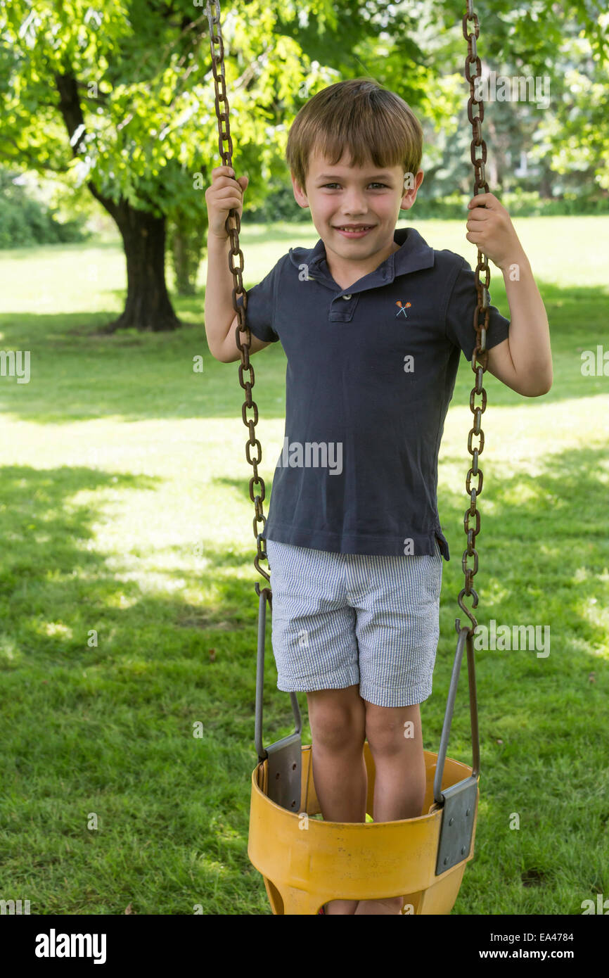 Young Boy Playing in Backyard Swing, USA Stock Photo Alamy