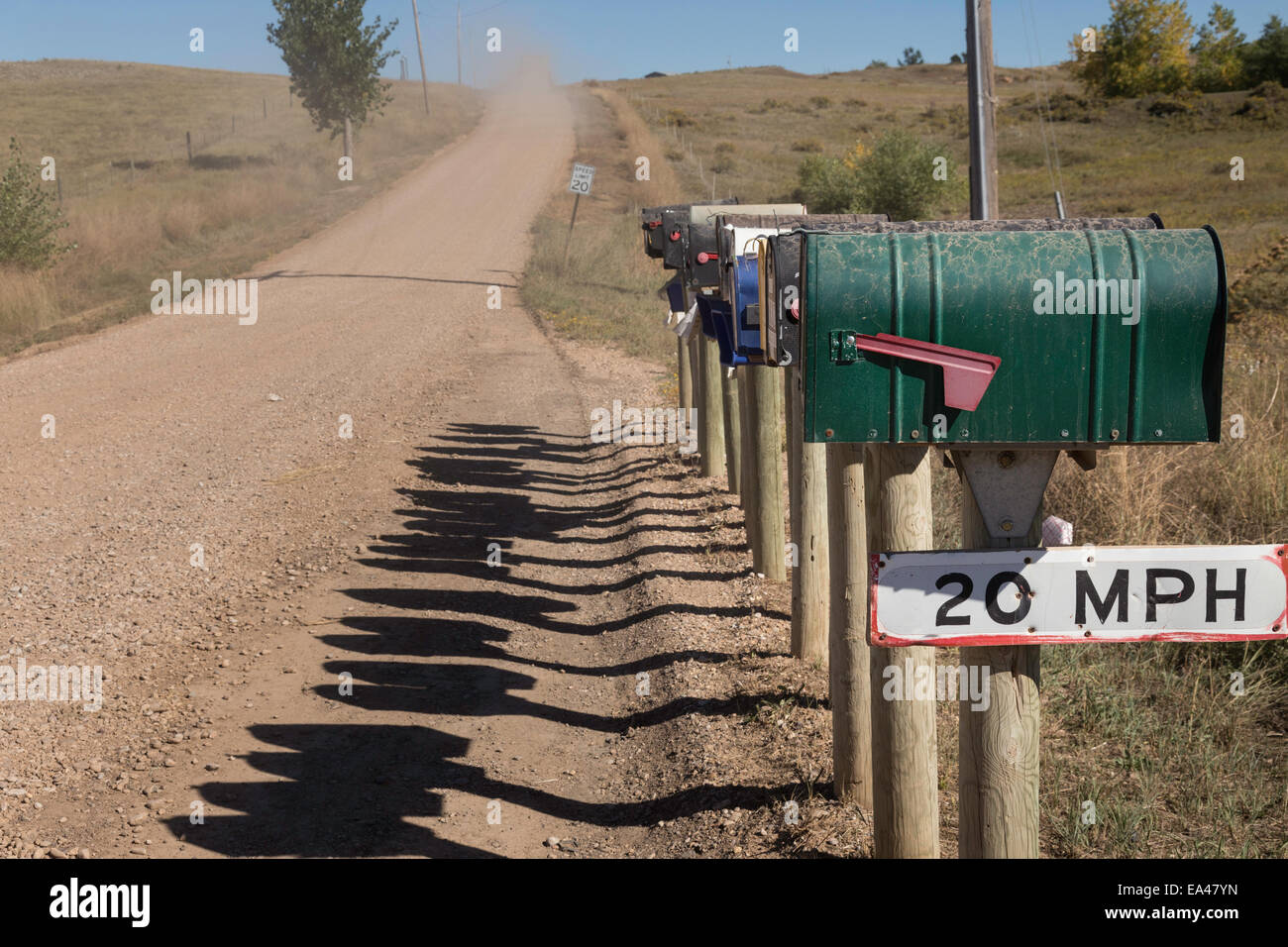 Line of Mailboxes (letterboxes) on Straight Rural Dirt Road, South Dakota, USA Stock Photo