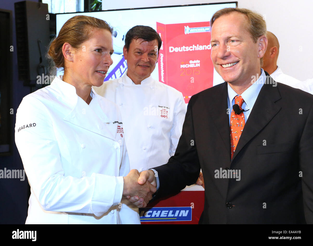 Berlin, Germany. 06th Nov, 2014. International head of the restaurant guide Guide Michelin, Michael L. Ellis congratulates the cook Sonja Fruehsammer of Fruehsammer restaurant during the presentation of the new top chefs of Germany in the 'Guide Michelin 2015' in Berlin, Germany, 06 November 2014. So far the top chef was nominated with one star. Credit:  dpa picture alliance/Alamy Live News Stock Photo