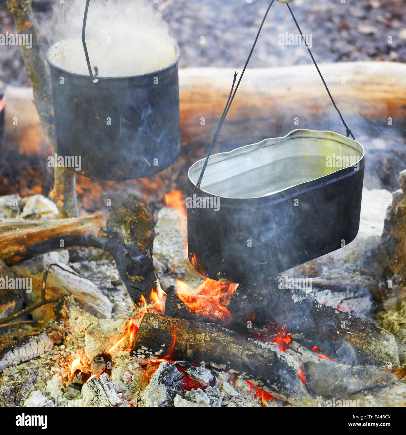 Boiling water in two pots above the fire Stock Photo Alamy