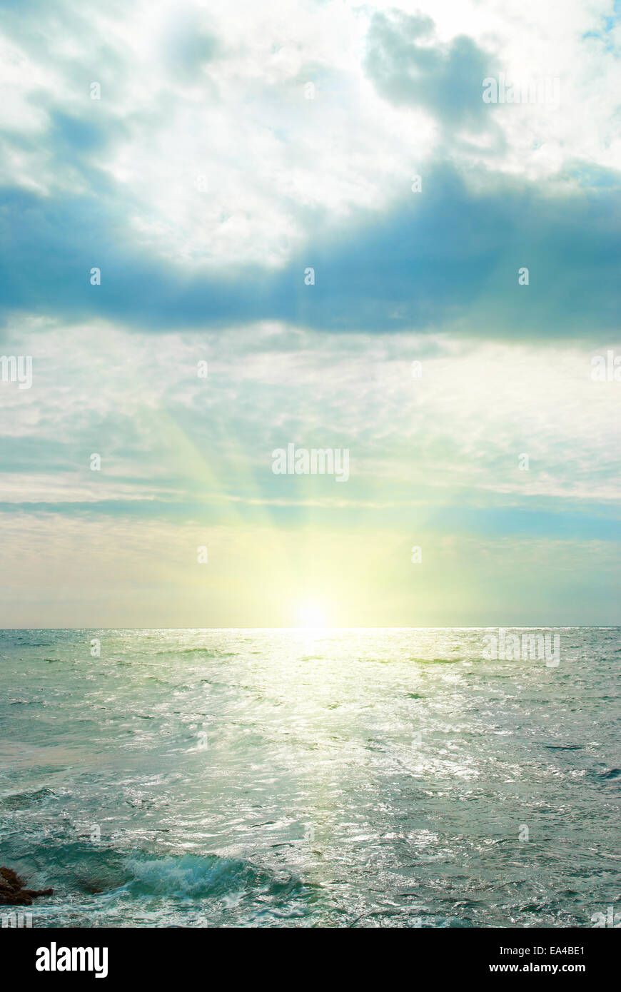 Sea, waves, sun and clouds. Sunset above the sea Stock Photo - Alamy