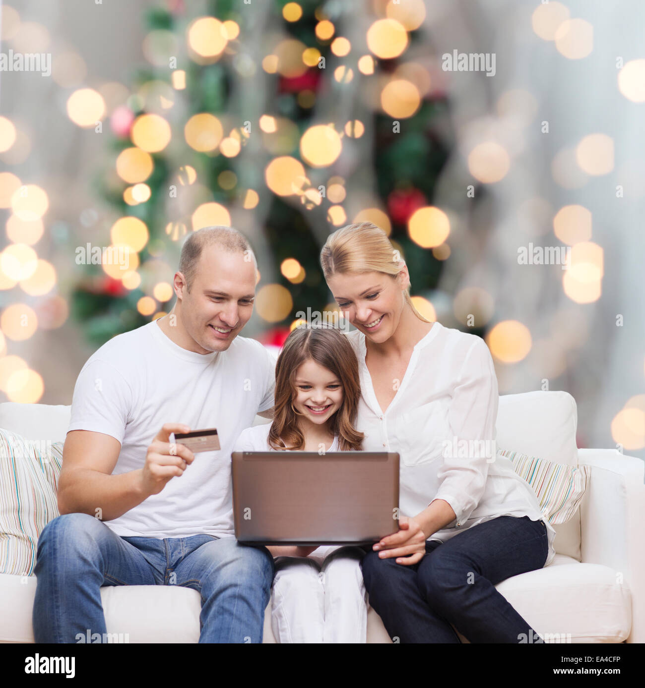 happy family with laptop computer and credit card Stock Photo