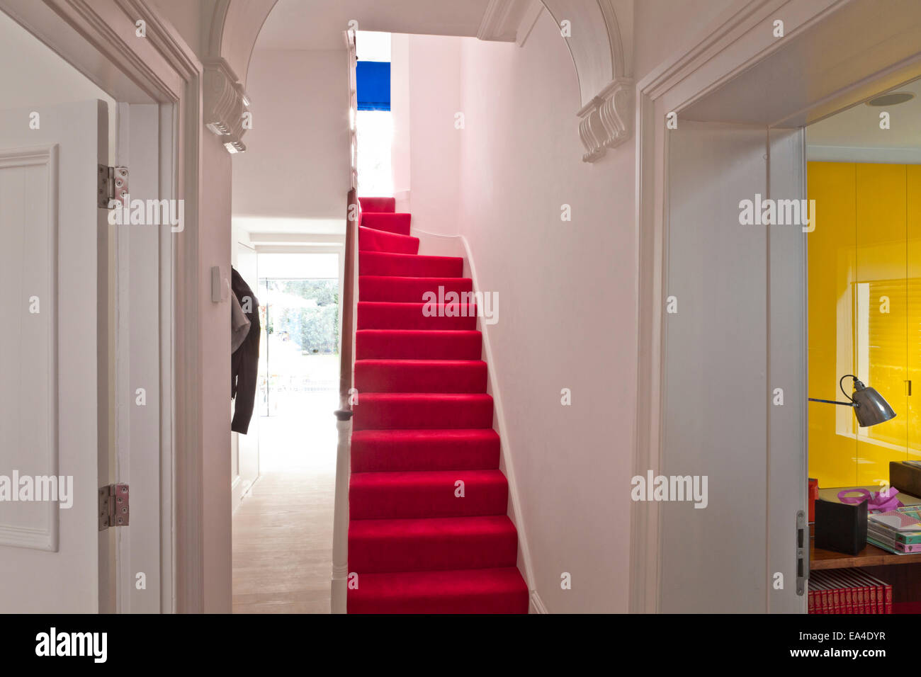 Red carpeted staircase in London home, UK. Stock Photo