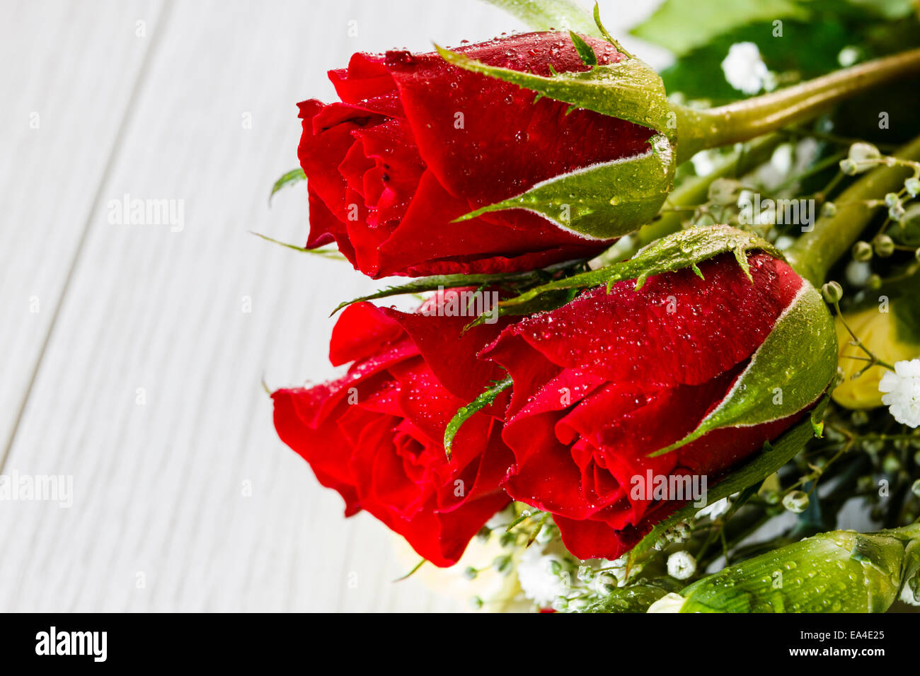 Bunch of mixed cut flowers, mainly red roses Stock Photo