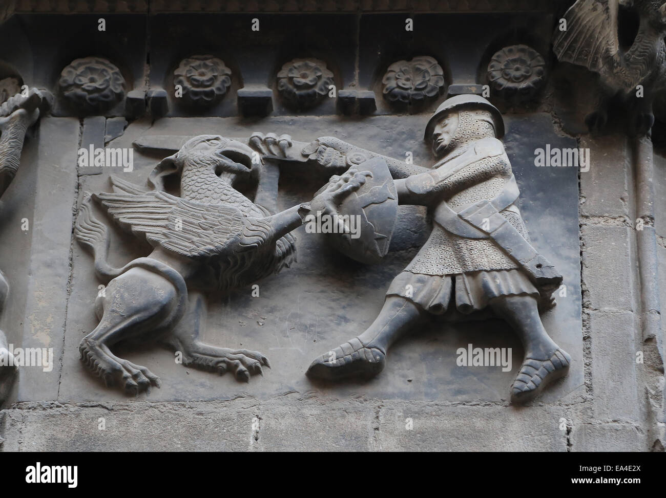 Spain. Catalonia. Barcelona Cathedral. Fightwith a Griffin in a relief of San Ivo Portal. Panels reused  Romanesque Cathedral. Stock Photo