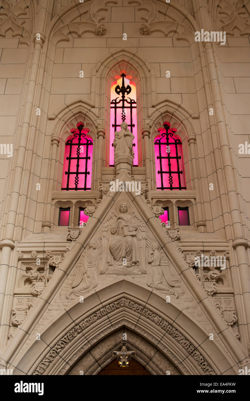 Ornate facade of a wall and pink stained glass windows; Ottawa, Ontario