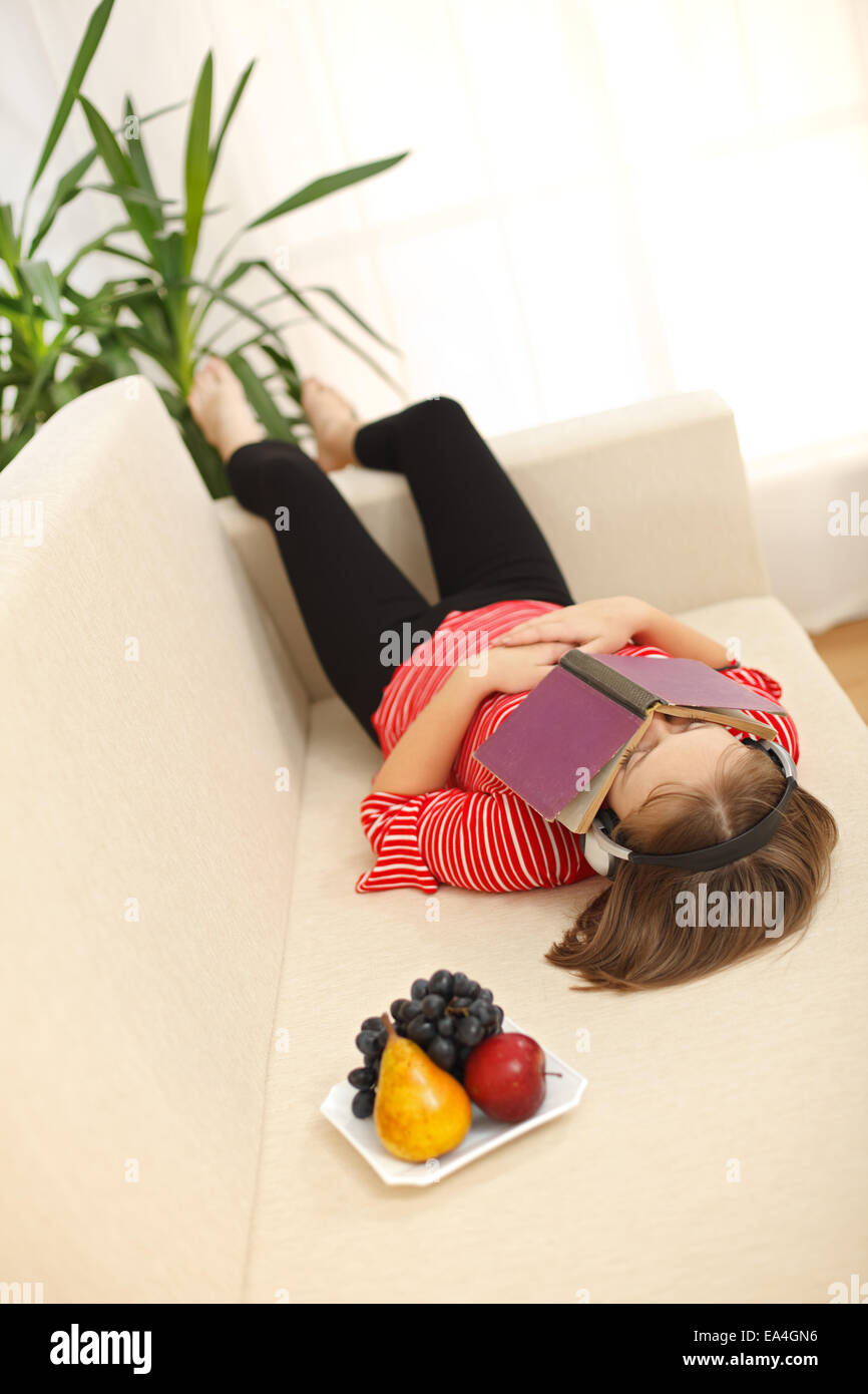 Teen girl laying on sofa hi-res stock photography and images - Alamy