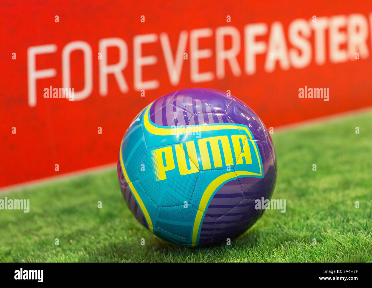 A PUMA football evoSPEED lying on the grass with Forever Faster slogan in  the background. COMMERCIAL HANDOUT/EDITORIAL USE ONLY/NO SALES. Please  quote the source "photo: PUMA/Ralf Roedel Stock Photo - Alamy