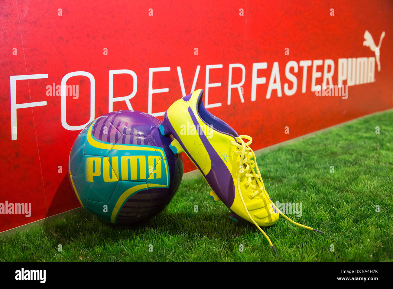 PUMA football boot evoSPEED (r.) and football evoPOWER lying on the grass  with Forever Faster slogan in the background. COMMERCIAL HANDOUT/EDITORIAL  USE ONLY/NO SALES. Please quote the source 