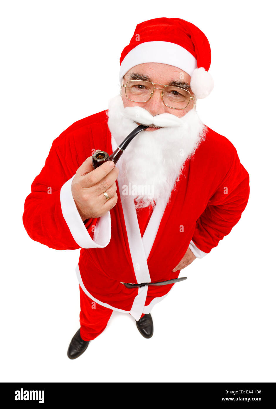 Senior man wearing Santa Claus uniform, holding pipe Stock Photo