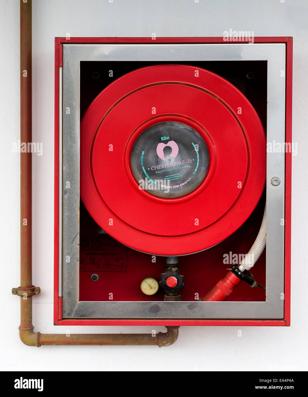 Fire hose in cabinet on wall, Puerto Carmen, Lanzarote, Canary Islands, Spain Stock Photo