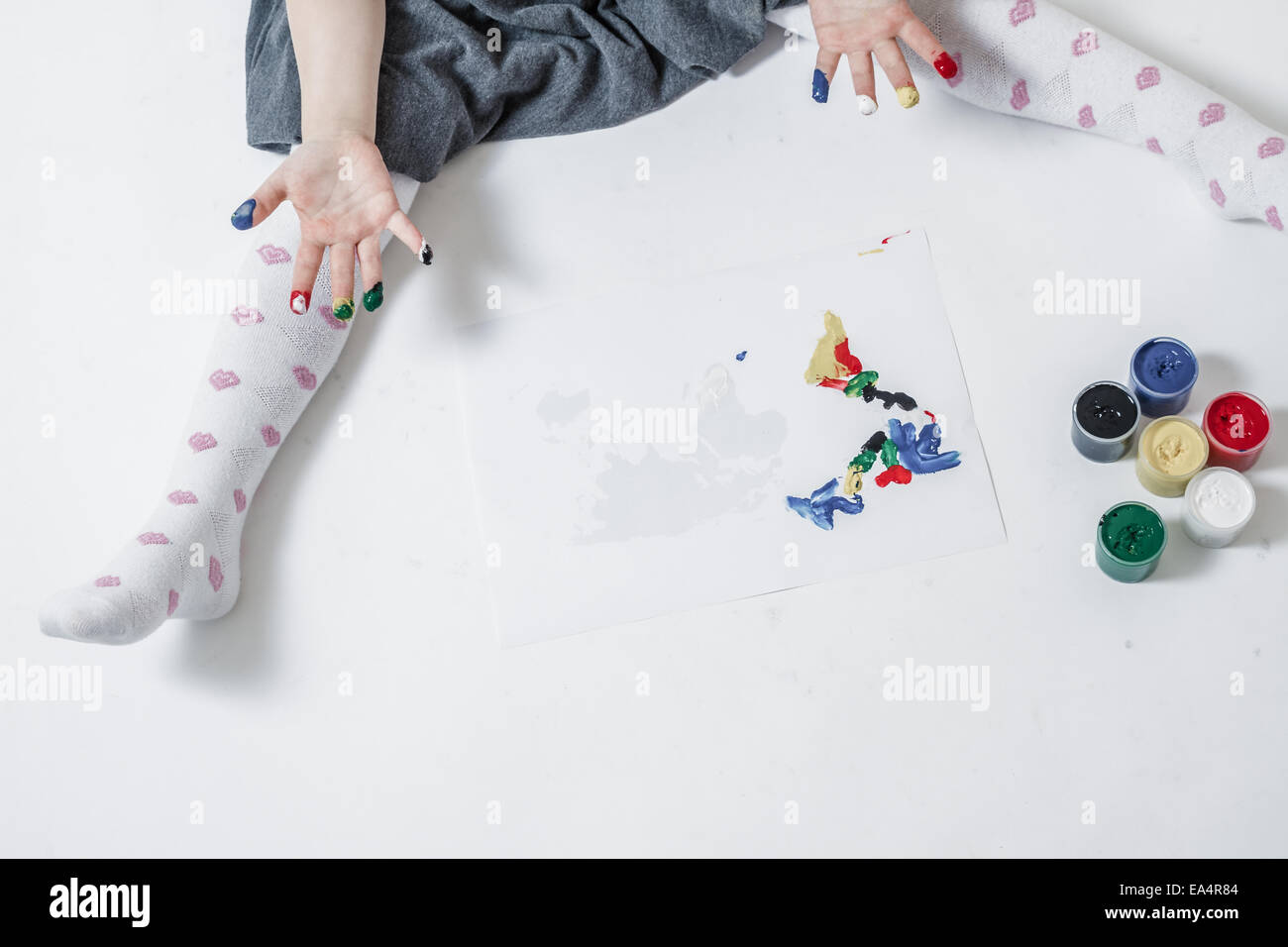 Llittle cute girl playing and painting with finger paint Stock Photo