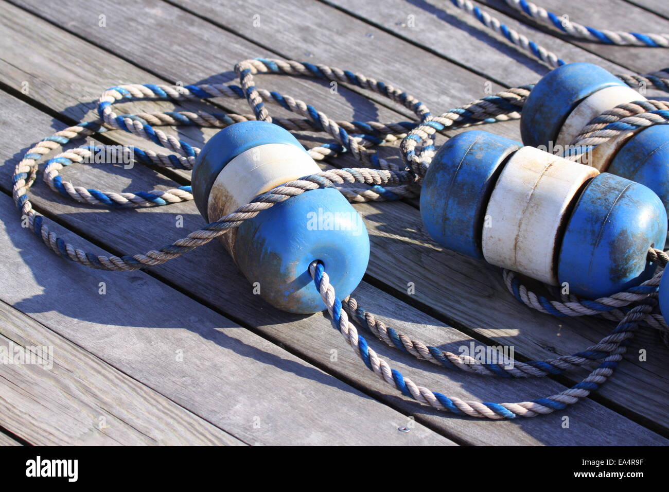 Nautical scene with blue buoys on a rope Stock Photo
