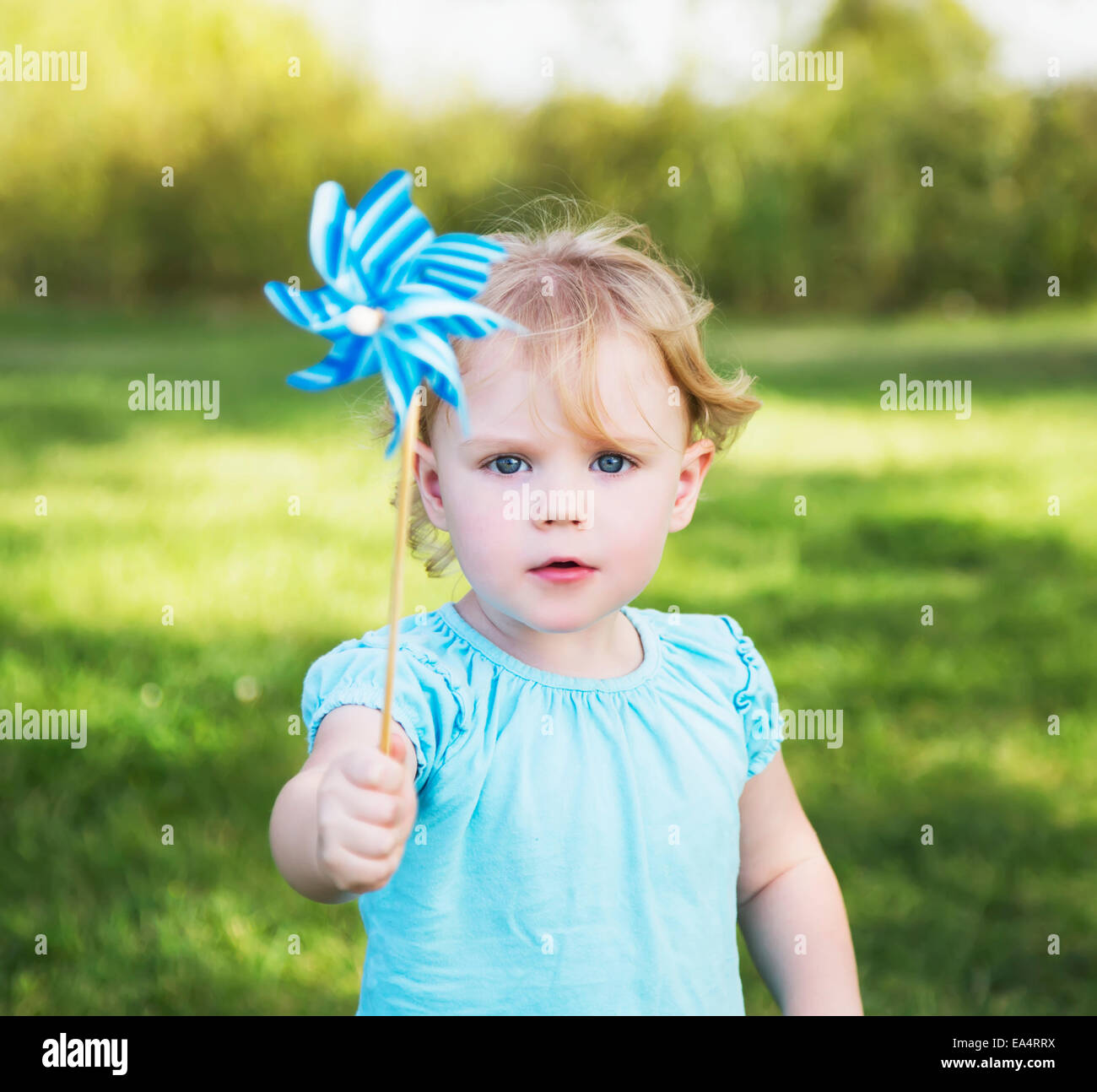 Young girl with pinwheel in a park; Edmonton, Alberta, Canada Stock Photo