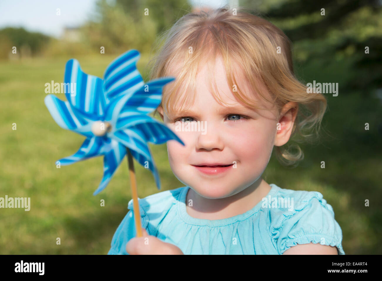 Young girl with pinwheel in a park; Edmonton, Alberta, Canada Stock Photo