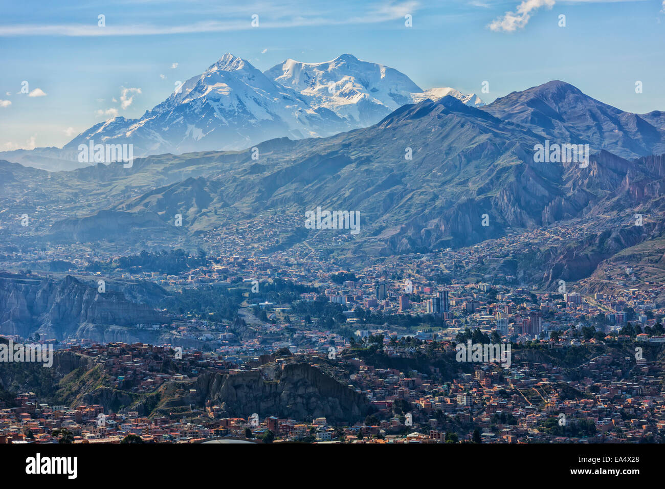The mountain Illimani rises above the skyline of La Paz; La Paz, Bolivia Stock Photo