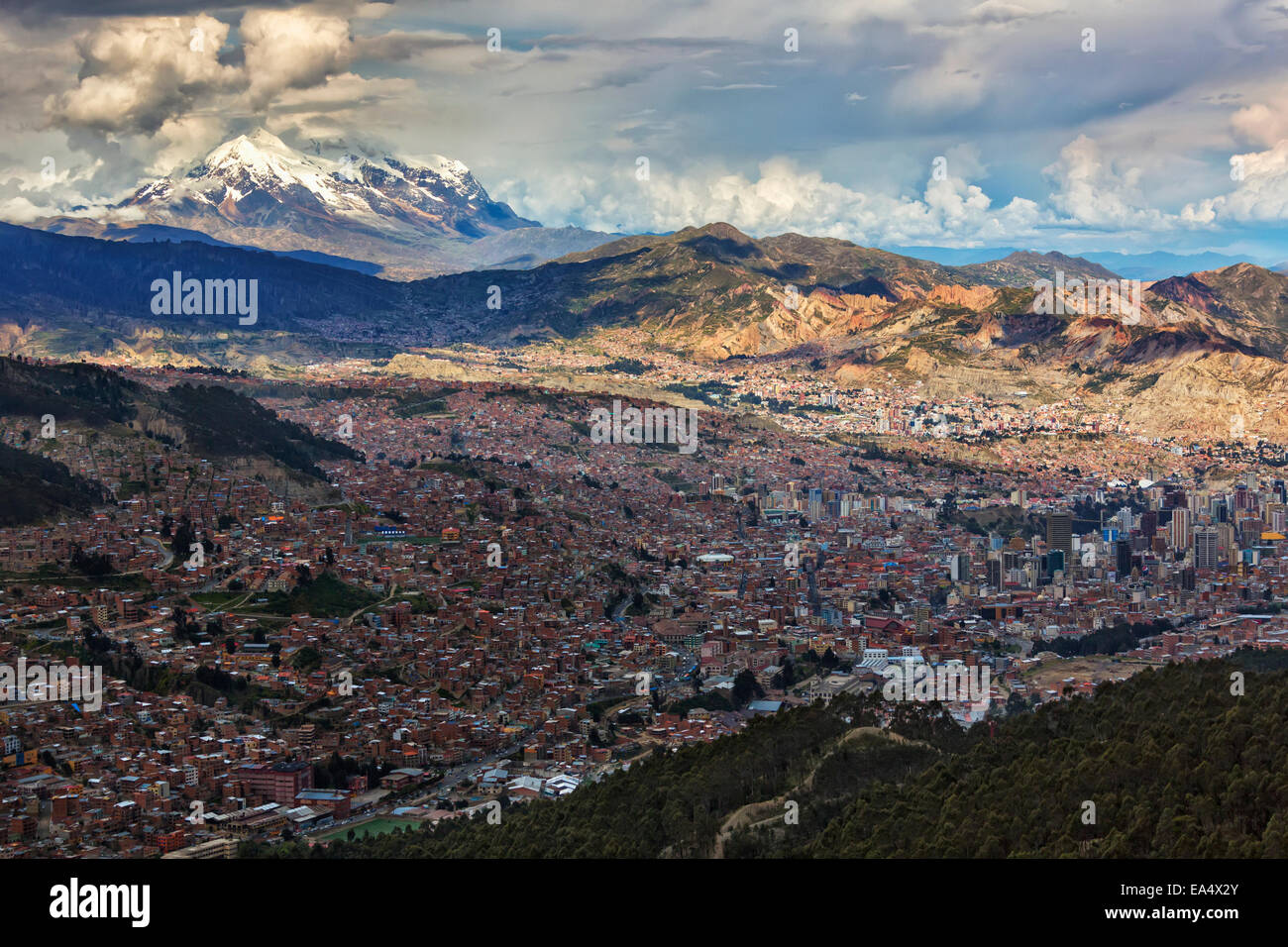 The city of La Paz with Illimani rising in the distance, the highest peak in Bolivia; La Paz, Bolivia Stock Photo
