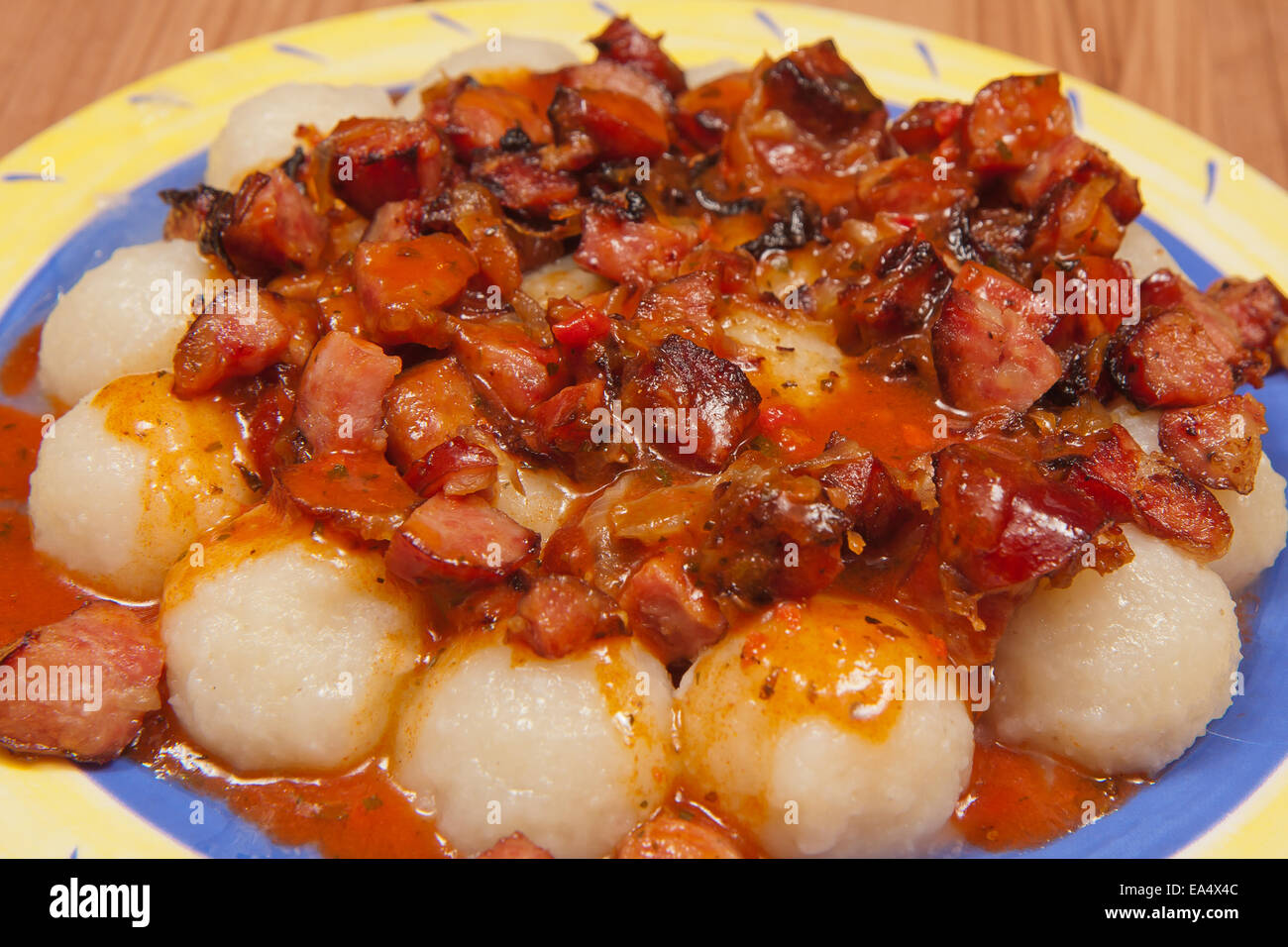 Slaskie dumplings with sausage and onion in  the sauce Stock Photo