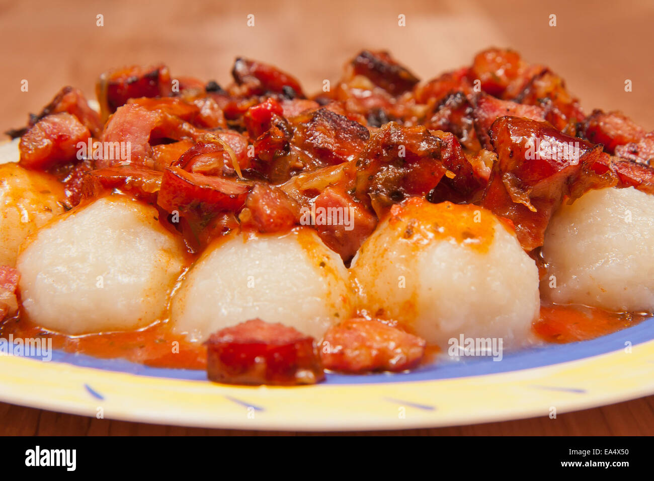 Ślaskie dumplings with sausage and onion in  the sauce Stock Photo