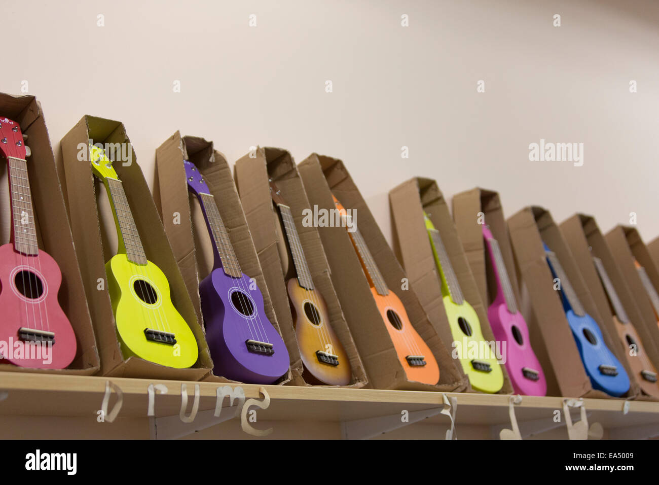 Row Of Ukuleles In Different Colours Stock Photo Alamy