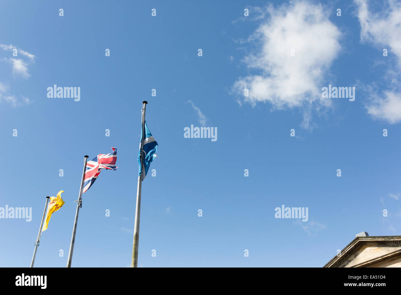 Flags on flag poles with blue sky Stock Photo - Alamy