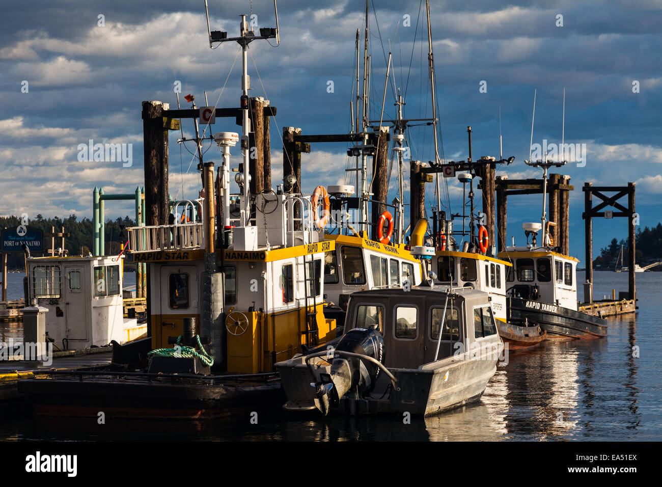 Row of logboom boats in Nanaimo harbour, British Columbia Stock Photo