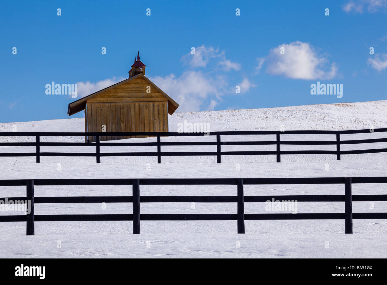 Winter farm scene with fences and shelter. Stock Photo