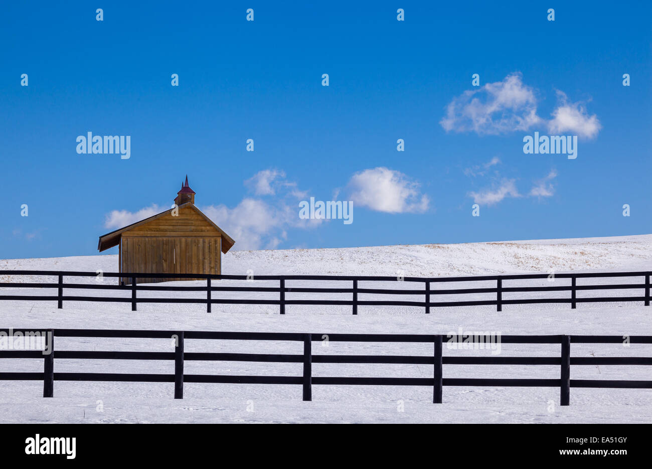 Winter farm scene with fences and shelter. Stock Photo