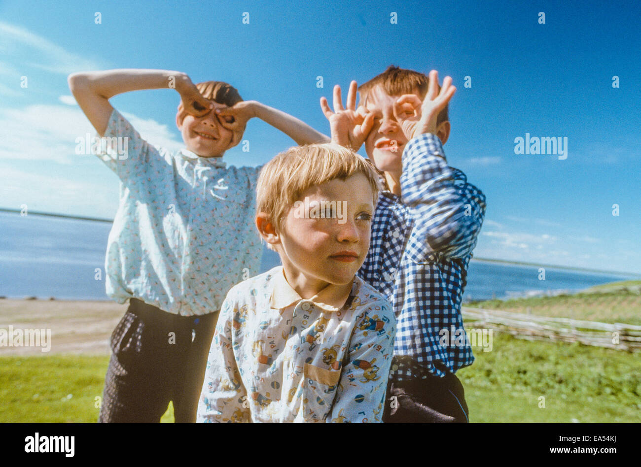 Three Siberian boys playing "Junior Birdman" with their hands inverted