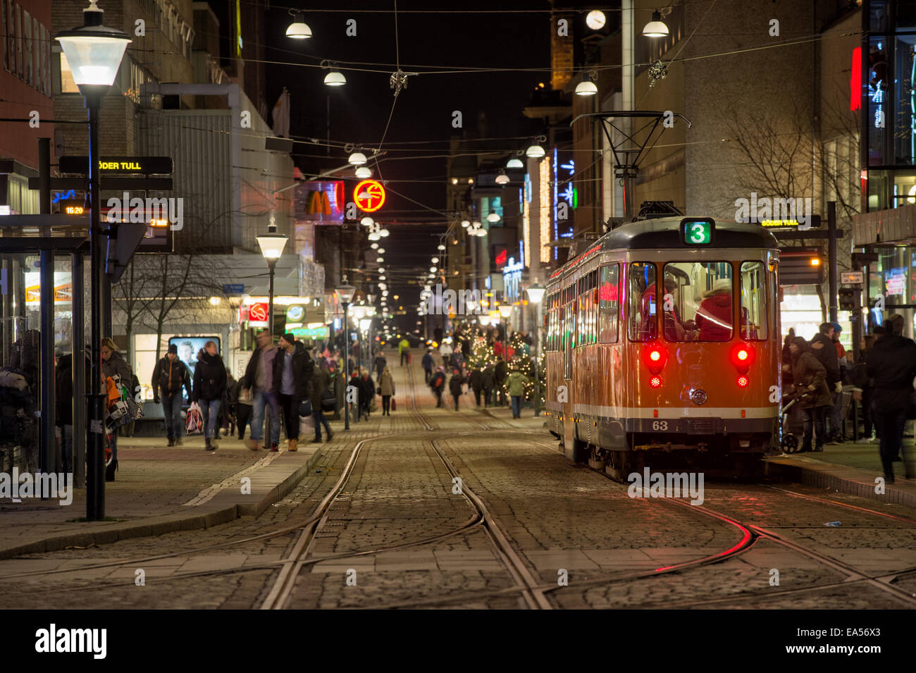 A tram makes a stop at Drottninggatan during Christmas time in Norrkoping, Sweden Stock Photo