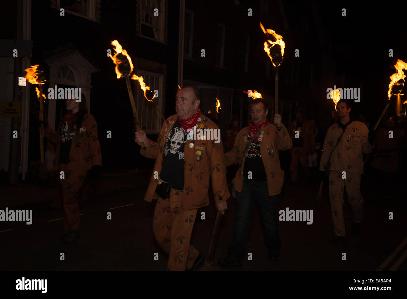 Lewes. Bonfire Night. Cliffe Bonfire society. A group of marches dressed in convict clothes march with burning torches Stock Photo