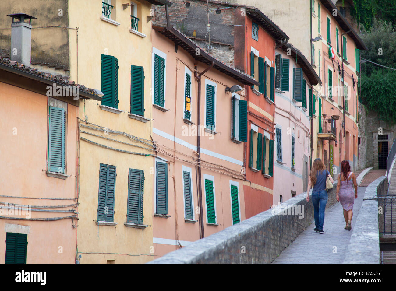 Woman walking along Via dei Priori, Perugia, Umbria, Italy Stock Photo