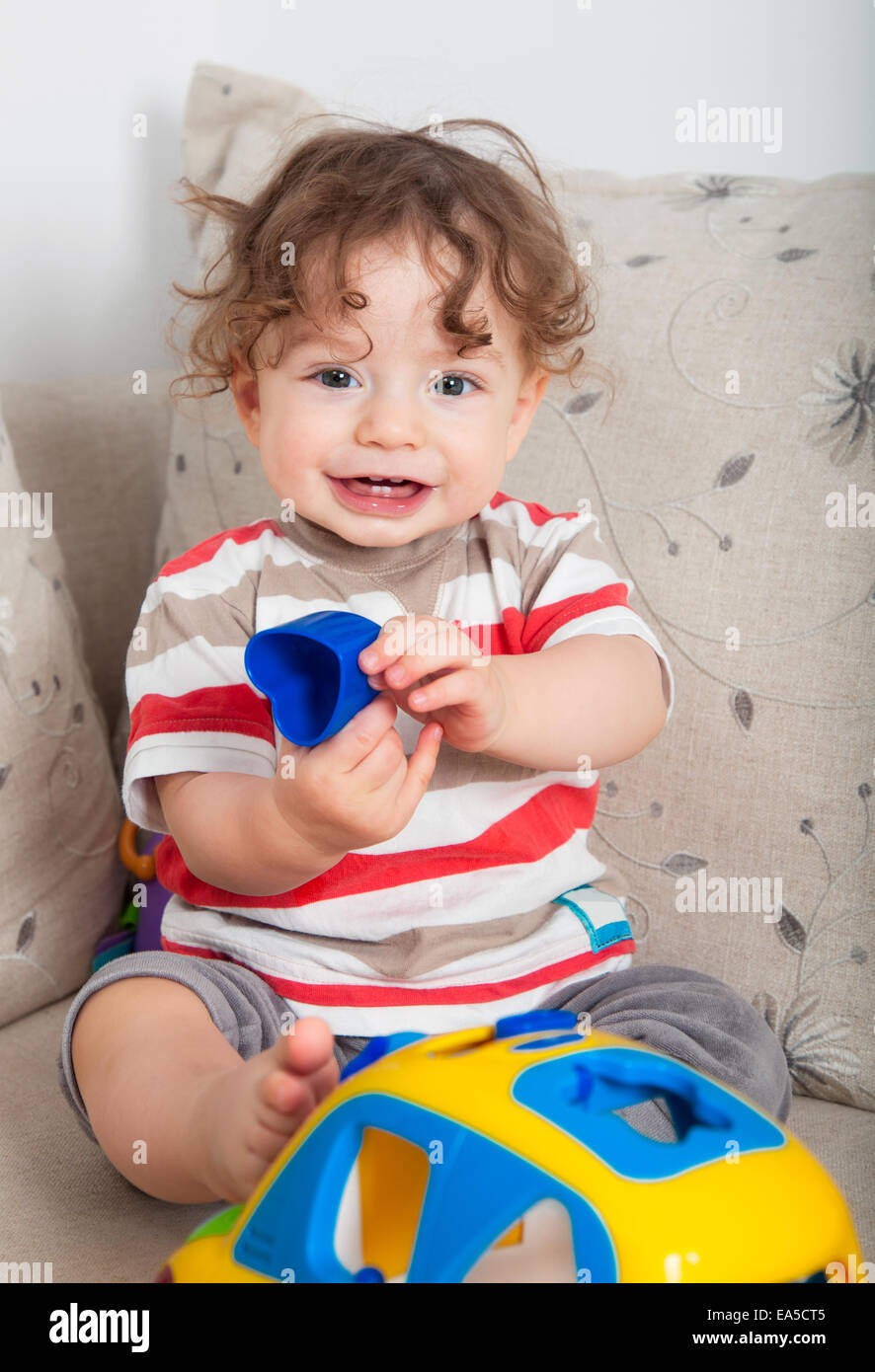 Baby boy playing with toy car at home Stock Photo - Alamy