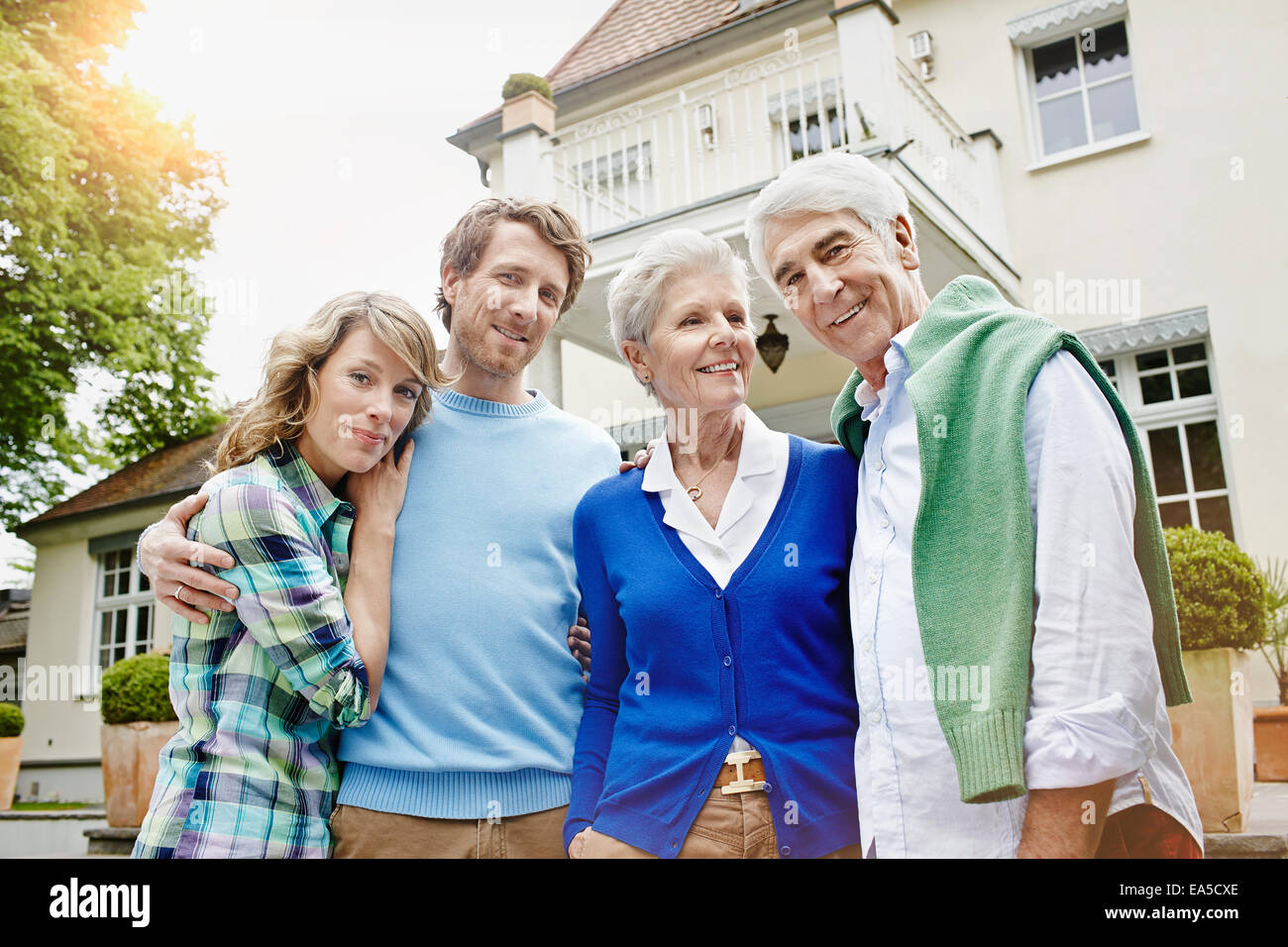 Germany, Hesse, Frankfurt, Senior couple with married children in front of villa Stock Photo