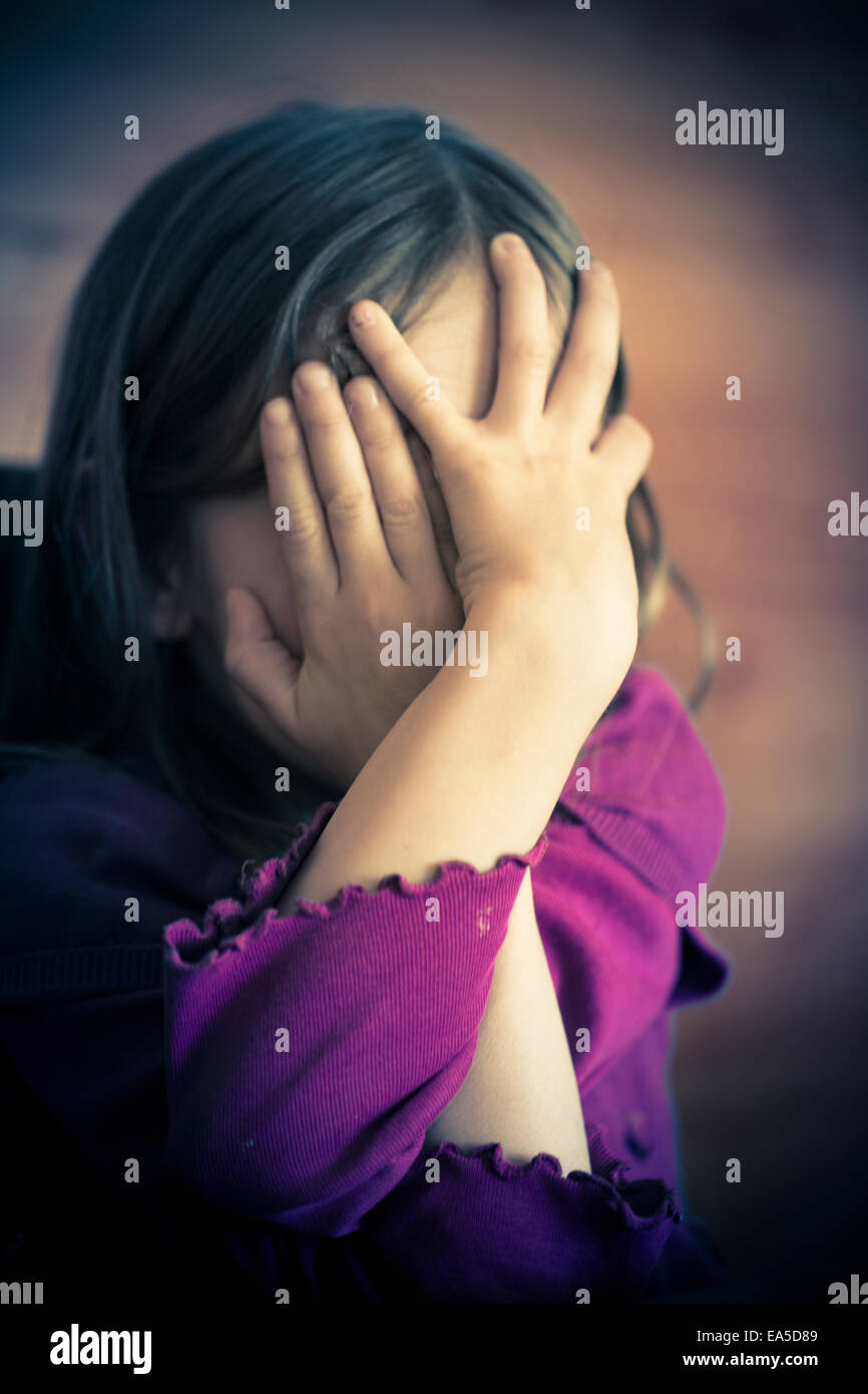 Child covering face with hands hi-res stock photography and images - Alamy