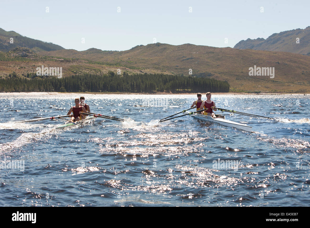 Two double scull rowing boats in water Stock Photo