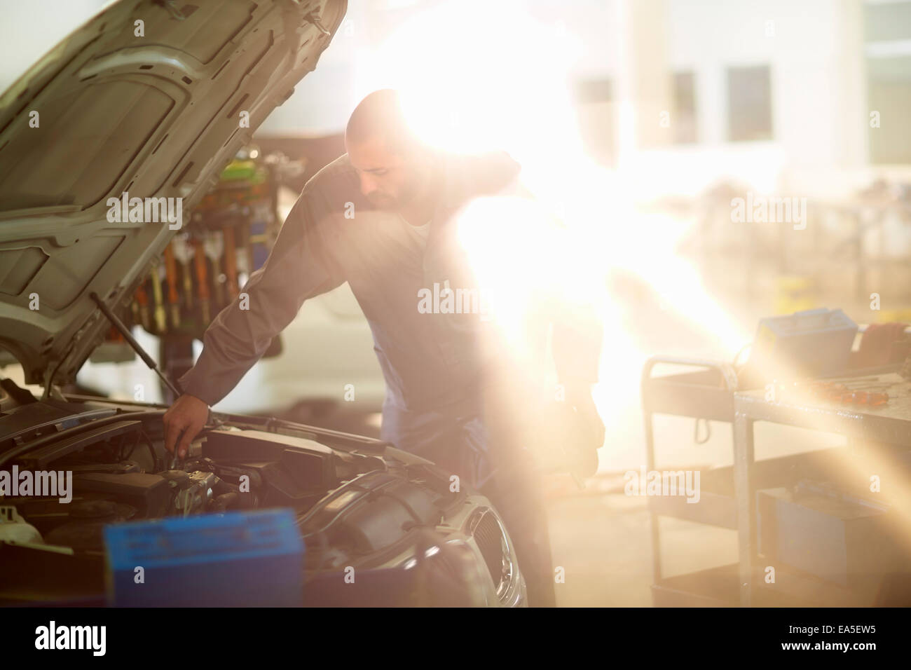 Workcomp Mechanic Car mechanic at work in repair garage Stock Photo - Alamy