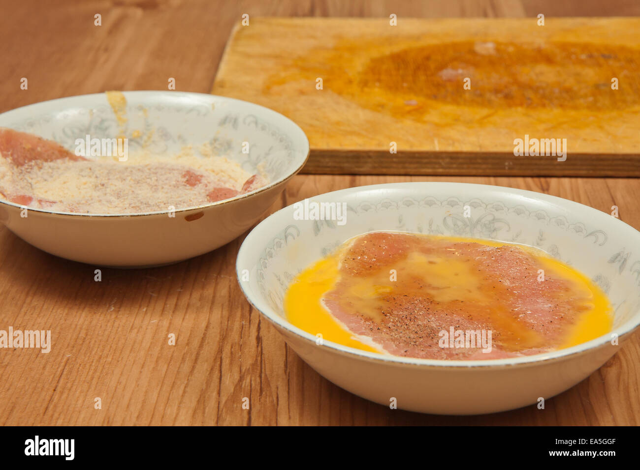 Eggs and breadcrumbs ready to prepare coating for the pork chops Stock