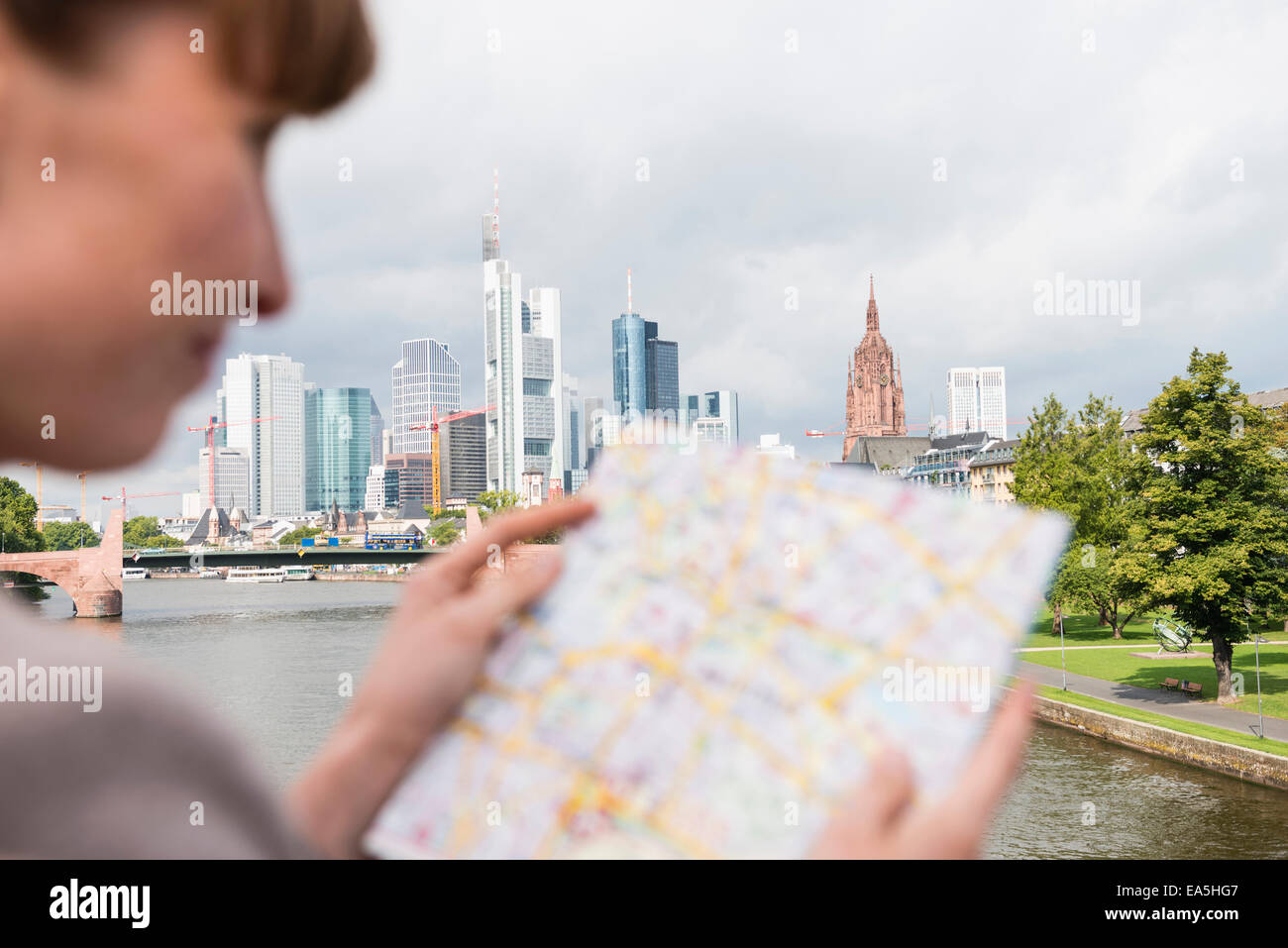 Germany, Hesse, Frankfurt, businesswoman reading city map Stock Photo