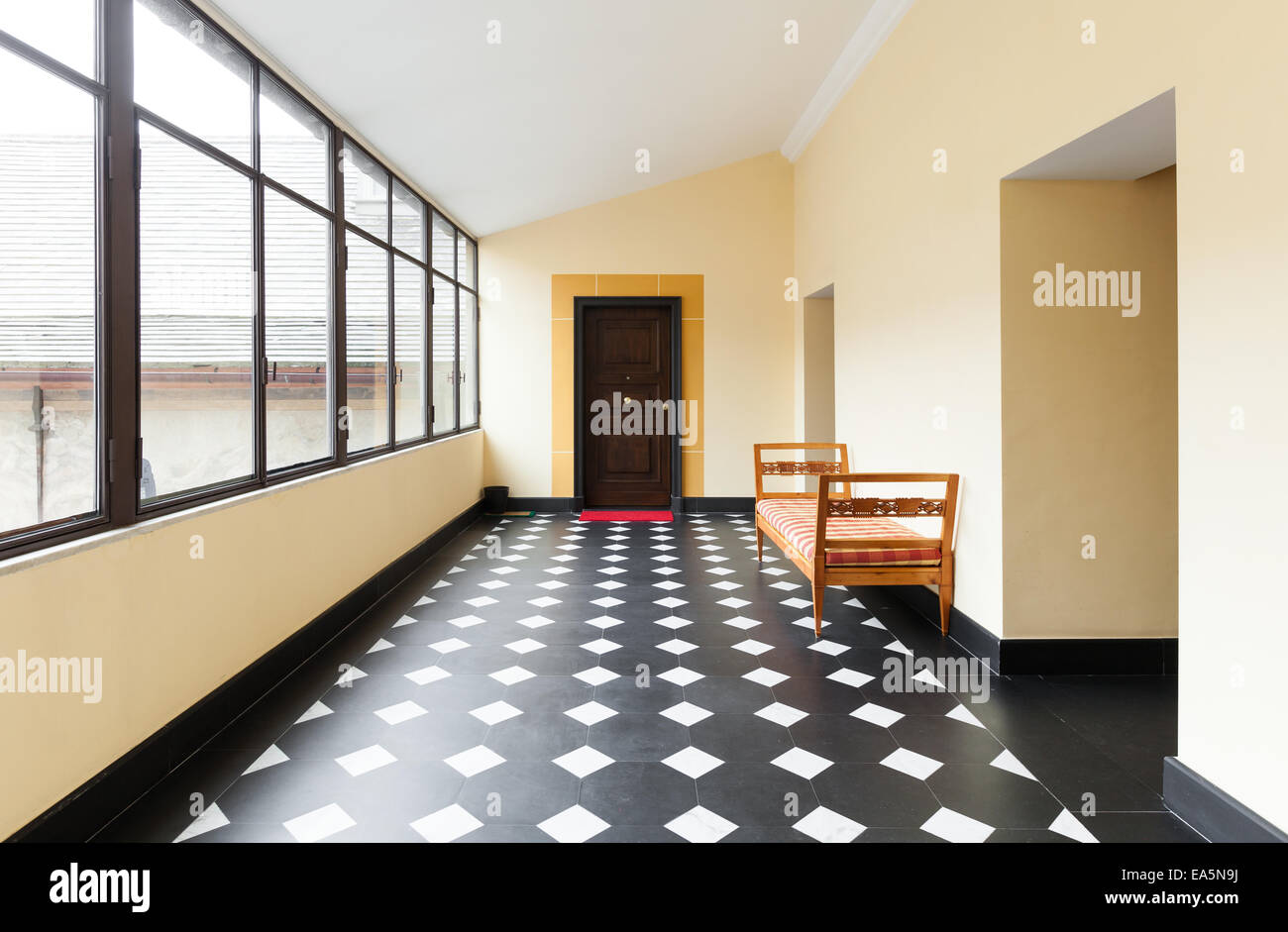 Hand-painted decoration on double doors in traditional with rush-seated  ladder-back chair and terracotta tiled floor Stock Photo - Alamy