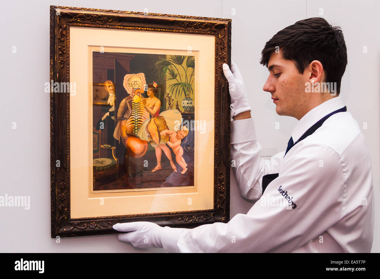 Sotheby's, Mayfair, London, November 7th 2014. Several outstanding examples of Czech avant-garde art from the Roy and Mary Cullen collection are to be auctioned by Sotheby’s on November 12th. PICTURED: A Sotheby's worker adjust the hanging of an untitled collage by Styrsky, which is expected to fetch up to £120,000 at auction. Credit:  Paul Davey/Alamy Live News Stock Photo