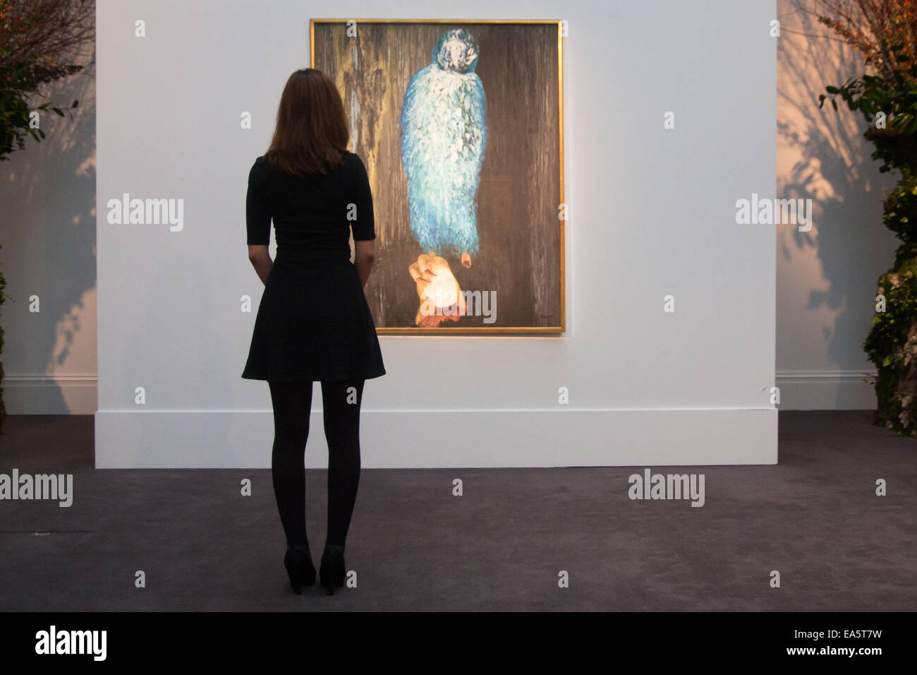 Sotheby's, Mayfair, London, November 7th 2014. Several outstanding examples of Czech avant-garde art from the Roy and Mary Cullen collection are to be auctioned by Sotheby’s on November 12th. PICTURED: A woman gazes at Toyen's The Message of the Forest, which is expected to fetch up to £1 million at auction. Credit:  Paul Davey/Alamy Live News Stock Photo