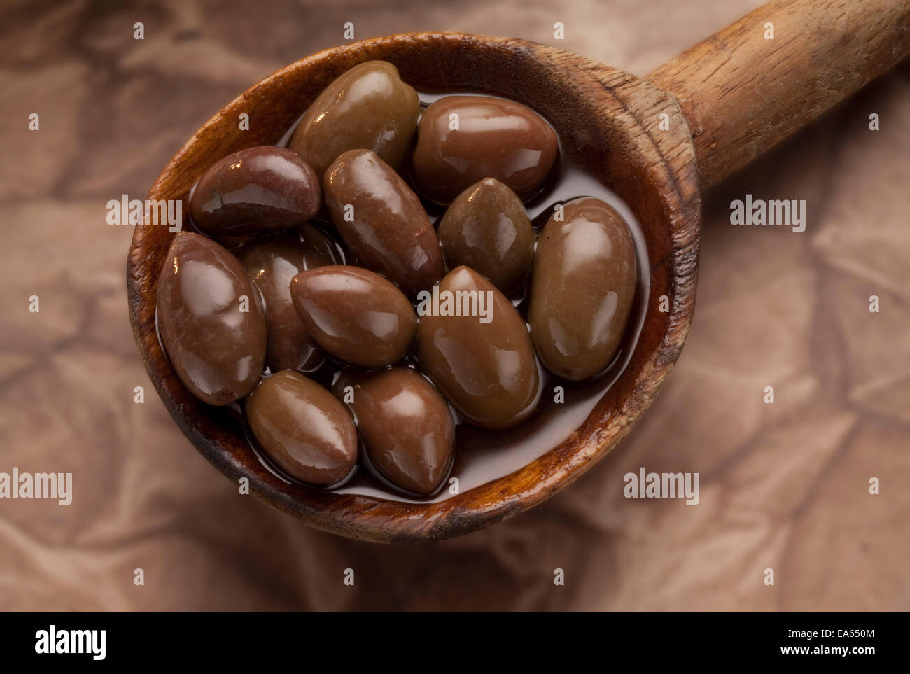 wooden spoon full of Kalamata olives Stock Photo