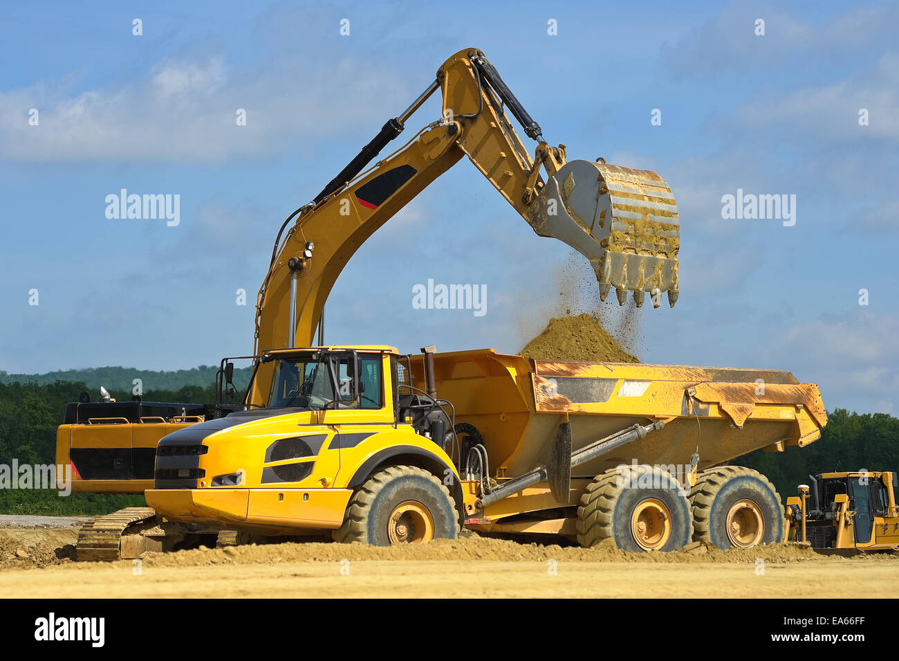 Dump truck is loaded by excavator Stock Photo
