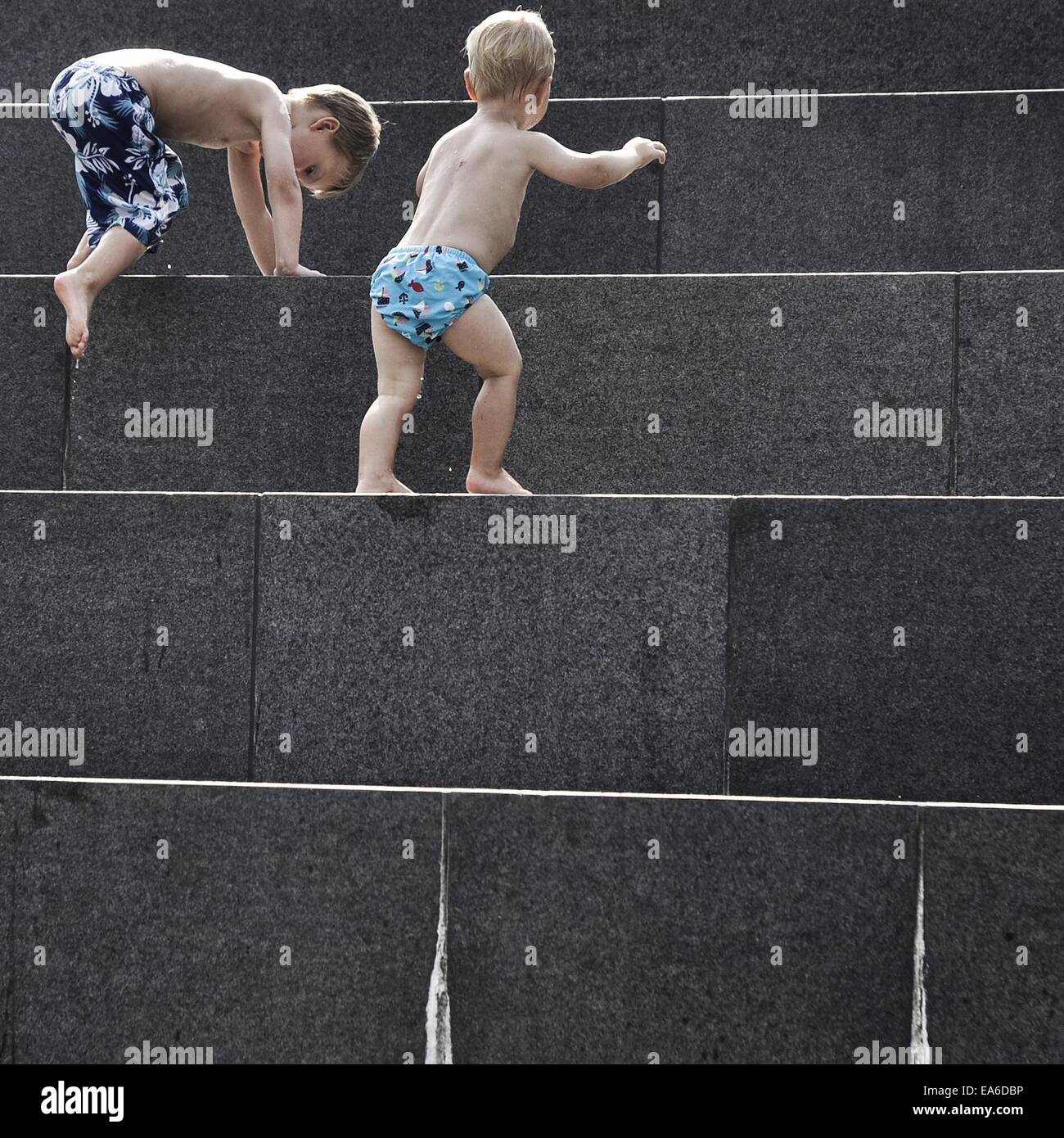 Boys climbing steps Stock Photo Alamy