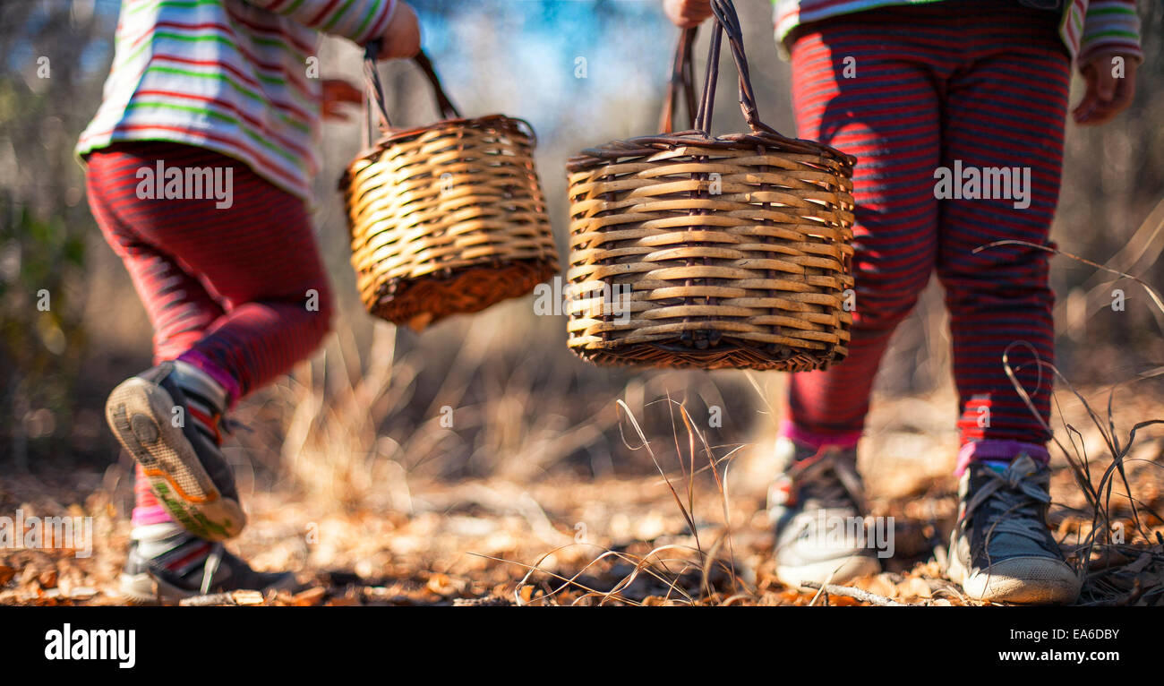 Two girls carrying baskets Stock Photo