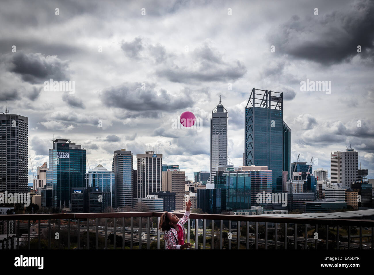 Australia, Western Australia, Perth, Girl throwing balloon into air Stock Photo